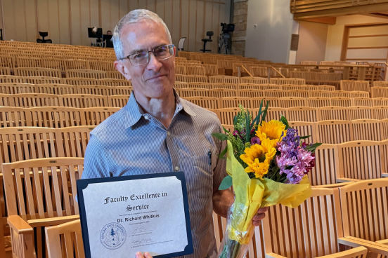 Dr. Richard Whitkus Dr. Richard Whitkus with flowers and award