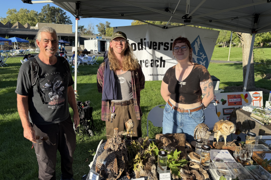 Professor and students tabling at promotional event