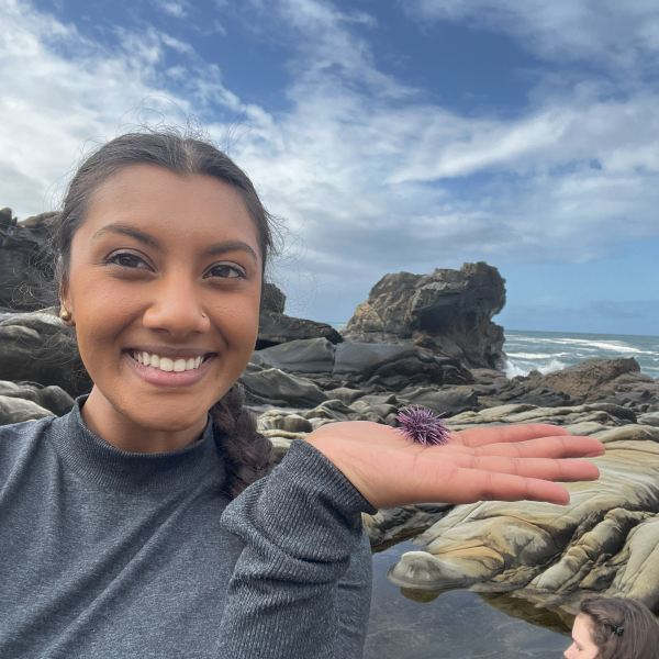 Student holding a sea urchin