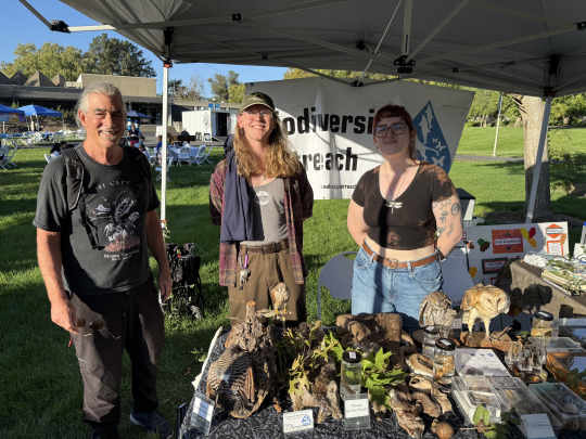 Professor and students tabling at promotional event