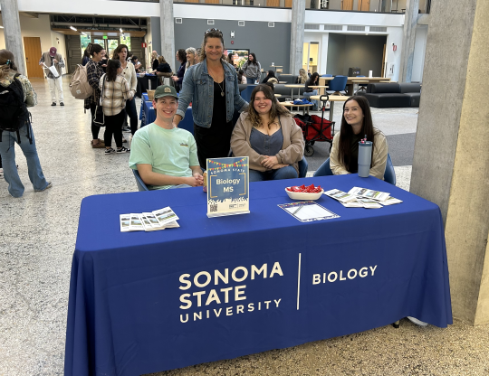 Students and Professor sitting at a table 