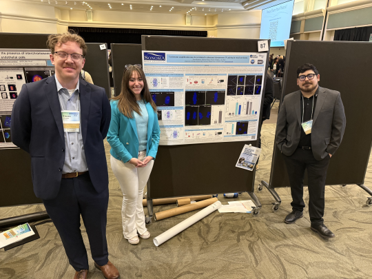 Students presenting posters at symposium event