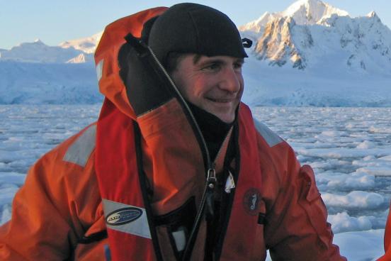 Dr. Dan Crocker in a boat in the arctic sea