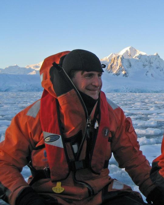 Dr. Dan Crocker in a boat in the arctic sea